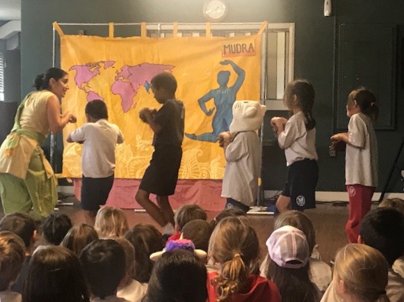 photo of performer leading a line of kids pretending to be mice